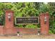 Welcoming brick entrance to The Cloisters community with a beautiful, wooded backdrop at 5105 Chemin De Vie, Atlanta, GA 30342