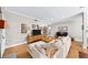 Bright living room with hardwood floors, neutral paint, and a stylish sofa with wood accent pieces at 5105 Chemin De Vie, Atlanta, GA 30342