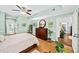 Bright main bedroom suite features hardwood floors, ceiling fan, and an ensuite bathroom at 5105 Chemin De Vie, Atlanta, GA 30342