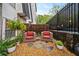 Serene patio with chairs, plants, and string lights creating a peaceful outdoor retreat at 5105 Chemin De Vie, Atlanta, GA 30342