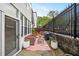 Cozy outdoor patio with seating, grill, string lights, and privacy fence at 5105 Chemin De Vie, Atlanta, GA 30342