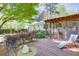 Spacious backyard featuring a deck, outdoor seating, mature trees, and a well-maintained garden at 2469 Hunting Valley Dr, Decatur, GA 30033