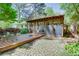 Picturesque backyard with a deck, paved patio, green grass, and mature trees providing shade and privacy at 2469 Hunting Valley Dr, Decatur, GA 30033