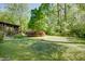 Expansive backyard featuring lush greenery and a covered patio area, ideal for outdoor entertaining and relaxation at 2469 Hunting Valley Dr, Decatur, GA 30033