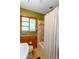 Bathroom featuring an earth-tone color scheme with matching tile backsplash, vanity, and shower with curtain at 2469 Hunting Valley Dr, Decatur, GA 30033