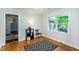 This bedroom features hardwood floors, wainscoting, an accent rug, and a window view of a landscaped yard at 2469 Hunting Valley Dr, Decatur, GA 30033