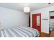 Bedroom featuring hardwood floors, a red closet door, and an en-suite bath at 2469 Hunting Valley Dr, Decatur, GA 30033