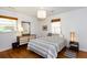 Bedroom with hardwood floors, two windows, mid-century furniture, and a patterned bedspread at 2469 Hunting Valley Dr, Decatur, GA 30033