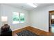 Bright bedroom features hardwood floors, a double window, and classic wainscoting for a clean, simple look at 2469 Hunting Valley Dr, Decatur, GA 30033