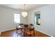 Bright dining area with wood floors, stylish chandelier, and natural light from two windows at 2469 Hunting Valley Dr, Decatur, GA 30033