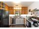 Cozy kitchen with wooden cabinets, stainless steel dishwasher, and laminate flooring at 2469 Hunting Valley Dr, Decatur, GA 30033