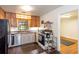 Well-lit kitchen boasts stainless steel dishwasher, wood cabinets, and view to breakfast nook at 2469 Hunting Valley Dr, Decatur, GA 30033