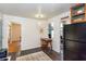 Kitchen area with black refrigerator, wood cabinet, desk area, and view to a dining room at 2469 Hunting Valley Dr, Decatur, GA 30033