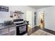 Kitchen includes shelves, an oven, and entryways into two other rooms with patterned rug at 2469 Hunting Valley Dr, Decatur, GA 30033