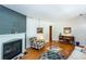 Comfortable living room featuring a fireplace, hardwood floors, and a stylish decor at 2469 Hunting Valley Dr, Decatur, GA 30033