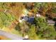 A serene aerial view showcases the property nestled among vibrant fall foliage and a sparkling pool at 2636 Harvest Se Dr, Conyers, GA 30013