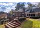 Expansive backyard featuring a wooden deck with pergola, lush lawn, and mature trees at 2636 Harvest Se Dr, Conyers, GA 30013
