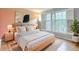 Cozy bedroom featuring a comfy bed, stylish lighting, and natural light from the windows at 2636 Harvest Se Dr, Conyers, GA 30013