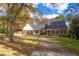 Charming brick home with black shutters, mature trees, and a curved driveway at 2636 Harvest Se Dr, Conyers, GA 30013