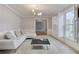 Bright living room with white sofa, shutters, and neutral decor at 2636 Harvest Se Dr, Conyers, GA 30013