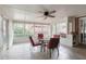 Bright sunroom with a glass table and red chairs, offering peaceful views of the outdoors at 2636 Harvest Se Dr, Conyers, GA 30013