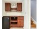 Basement wet bar with mini refrigerator, cabinets, and decorative accents at 2636 Harvest Se Dr, Conyers, GA 30013