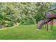 Spacious back yard featuring lush lawn, wood privacy fence, and a staircase to the deck at 3790 Willow Ridge Rd, Douglasville, GA 30135