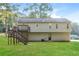 The back of the home features a spacious deck with stairs leading to a well-maintained lawn at 3790 Willow Ridge Rd, Douglasville, GA 30135