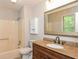 Bathroom featuring granite countertop, wooden cabinets, and shower-tub combination at 3790 Willow Ridge Rd, Douglasville, GA 30135
