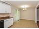Bright dining area with tile flooring, adjacent to the kitchen, and patio access at 3790 Willow Ridge Rd, Douglasville, GA 30135