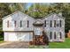 Charming split-level home with well-maintained lawn, attached garage, and inviting front porch at 3790 Willow Ridge Rd, Douglasville, GA 30135