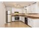 Well-equipped kitchen with stainless steel appliances, white cabinets, and tiled backsplash at 3790 Willow Ridge Rd, Douglasville, GA 30135