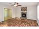 Inviting living room featuring a stone fireplace, ceiling fan, and beautiful wood flooring at 3790 Willow Ridge Rd, Douglasville, GA 30135