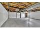 Unfinished basement space with concrete floor, open ceiling, and painted white walls at 4973 Gunners Ne Pass, Roswell, GA 30075