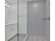 Sleek, tiled bathroom showcasing a glass-enclosed shower with a patterned tile floor and chrome fixtures at 4973 Gunners Ne Pass, Roswell, GA 30075