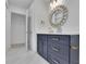 Updated bathroom featuring navy blue vanity with gold hardware and a decorative mirror at 4973 Gunners Ne Pass, Roswell, GA 30075