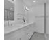 Bright bathroom featuring double sinks, white cabinetry, and modern fixtures under sleek vanity lighting at 4973 Gunners Ne Pass, Roswell, GA 30075
