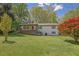 Charming one-story home with a brick facade, inviting front porch, and spacious front yard at 4973 Gunners Ne Pass, Roswell, GA 30075