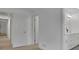 Hallway with hard surface floors leading to an updated bathroom at 4973 Gunners Ne Pass, Roswell, GA 30075