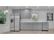 Modern kitchen featuring gray cabinets, stainless steel appliances, and white subway tile backsplash at 4973 Gunners Ne Pass, Roswell, GA 30075