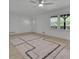 Bright living room with ceiling fan, natural light, and modern area rug on top of light hardwood flooring at 4973 Gunners Ne Pass, Roswell, GA 30075