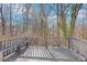 Back deck with wooden railings overlooking a wooded yard at 5465 N Fork Sw Dr, Lilburn, GA 30047
