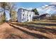 Backyard view featuring a white two-story house with a deck at 5465 N Fork Sw Dr, Lilburn, GA 30047