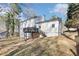 Backyard view of a white two-story house with a small deck at 5465 N Fork Sw Dr, Lilburn, GA 30047