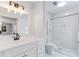 Bathroom featuring a new vanity, modern light fixture, and walk-in shower with glass doors at 5465 N Fork Sw Dr, Lilburn, GA 30047