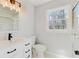Bathroom featuring a new vanity, modern light fixture, and a walk-in shower with glass doors at 5465 N Fork Sw Dr, Lilburn, GA 30047