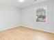 This bedroom includes hardwood floors and a large window overlooking the front yard at 5465 N Fork Sw Dr, Lilburn, GA 30047