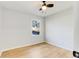 This bedroom includes hardwood floors, ceiling fan, and a front yard view at 5465 N Fork Sw Dr, Lilburn, GA 30047