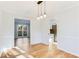 Dining room with wood flooring, modern light fixture, with access to the kitchen at 5465 N Fork Sw Dr, Lilburn, GA 30047