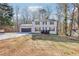 Charming two-story home with a well-maintained lawn, a black front porch, and a two-car garage at 5465 N Fork Sw Dr, Lilburn, GA 30047